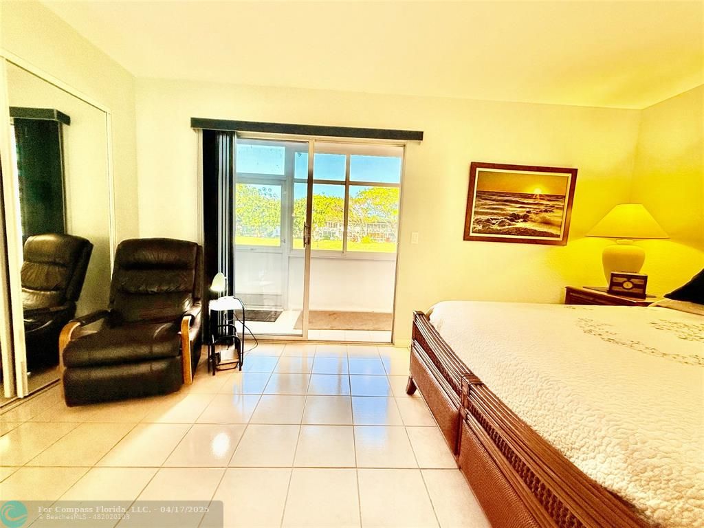 42 Tilford C, Unit 42 Deerfield Beach, FL 33442 - Photo 17 of 50 a bedroom with furniture and a large window