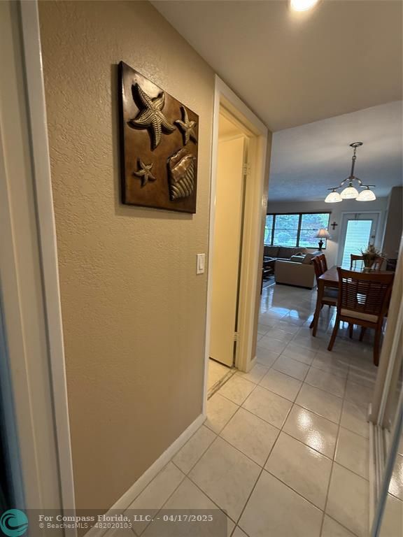 42 Tilford C, Unit 42 Deerfield Beach, FL 33442 - Photo 23 of 50 a dining room with furniture and a chandelier