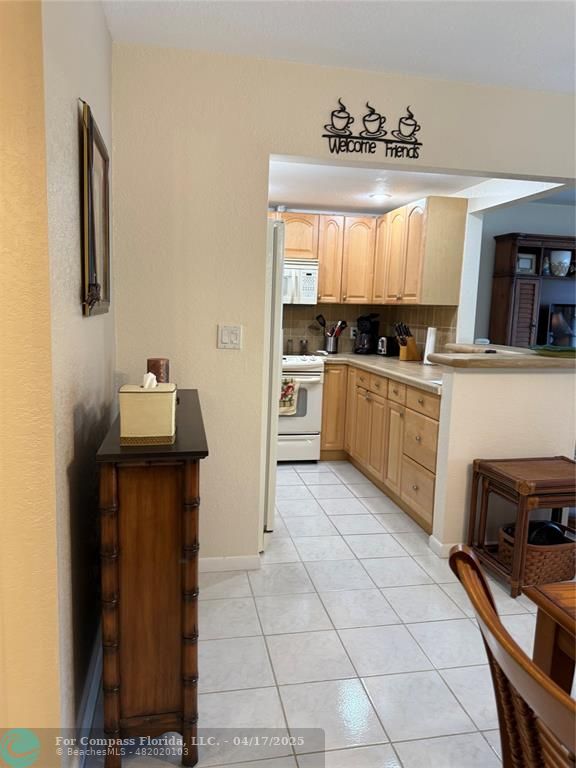 42 Tilford C, Unit 42 Deerfield Beach, FL 33442 - Photo 24 of 50 a kitchen with a stove a sink and a refrigerator