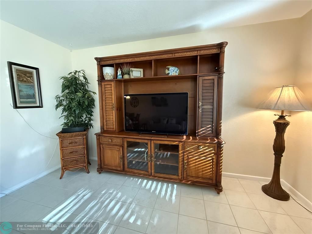 42 Tilford C, Unit 42 Deerfield Beach, FL 33442 - Photo 25 of 50 a living room with furniture and a flat screen tv