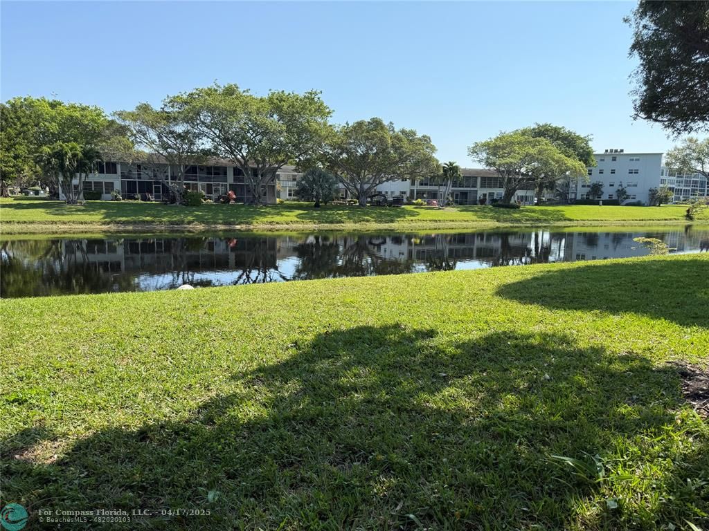 42 Tilford C, Unit 42 Deerfield Beach, FL 33442 - Photo 31 of 50 a view of a lake with houses in the background
