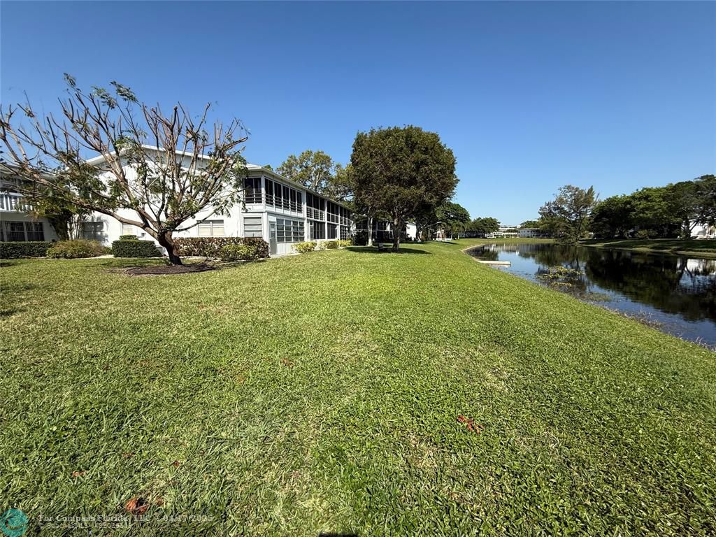 42 Tilford C, Unit 42 Deerfield Beach, FL 33442 - Photo 35 of 50 a view of a field of grass and trees