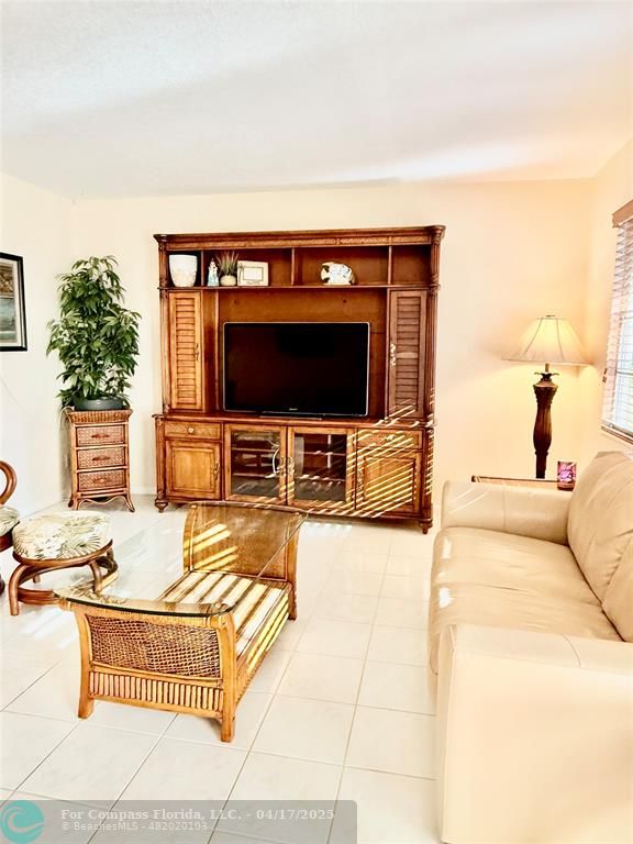 42 Tilford C, Unit 42 Deerfield Beach, FL 33442 - Photo 44 of 50 a living room with furniture and a flat screen tv