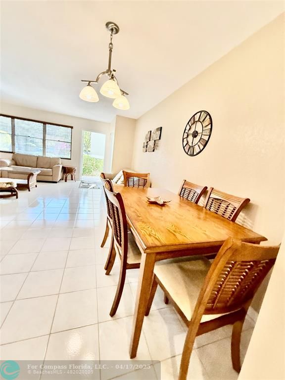 42 Tilford C, Unit 42 Deerfield Beach, FL 33442 - Photo 47 of 50 a view of a dining room with furniture and chandelier