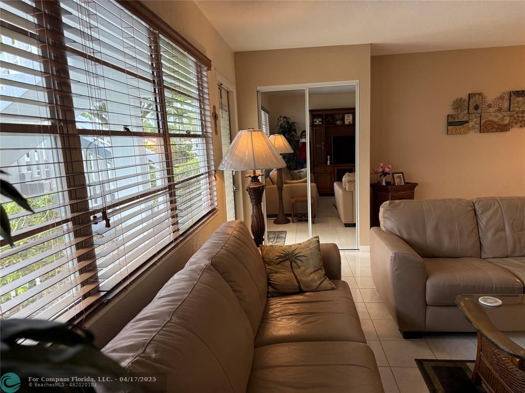 42 Tilford C, Unit 42 Deerfield Beach, FL 33442 - Photo 48 of 50 a living room with furniture and a large window
