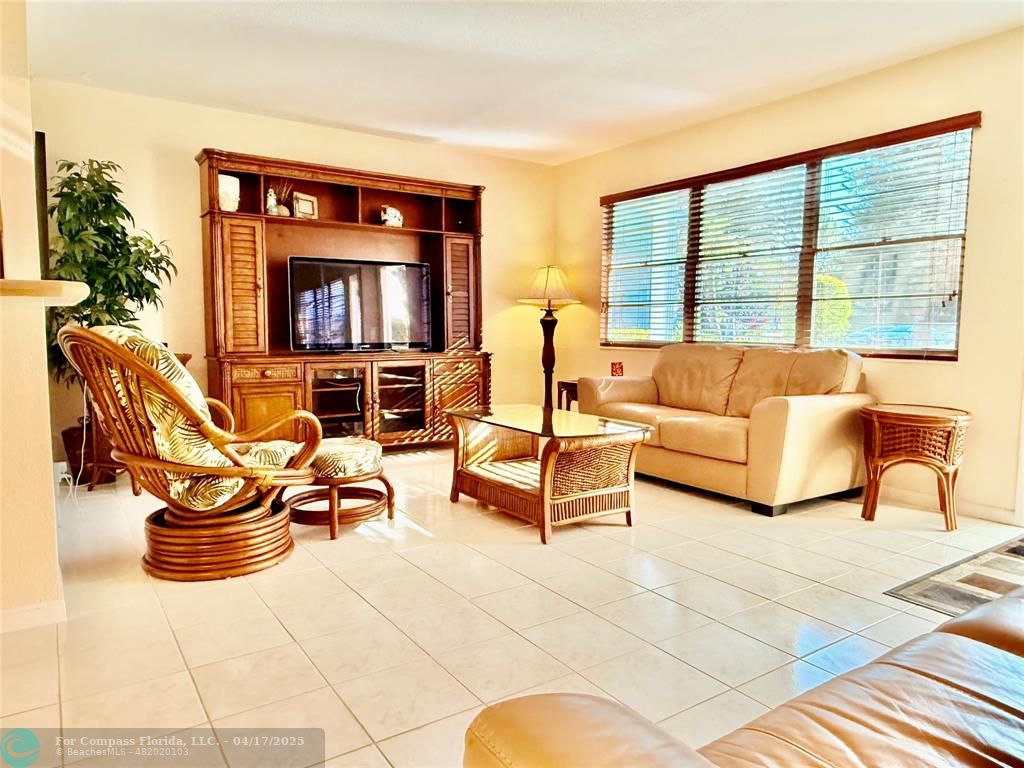 42 Tilford C, Unit 42 Deerfield Beach, FL 33442 - Photo 6 of 50 a living room with furniture and a flat screen tv