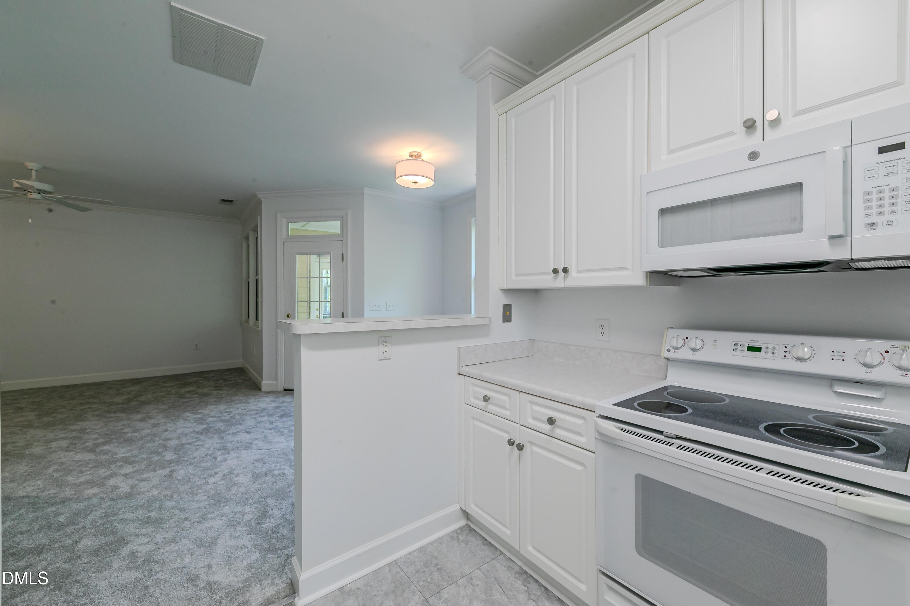 116 Northbrook Drive, Unit 305 Raleigh, NC 27609 - Photo 17 of 43 a kitchen with white cabinets and white appliances