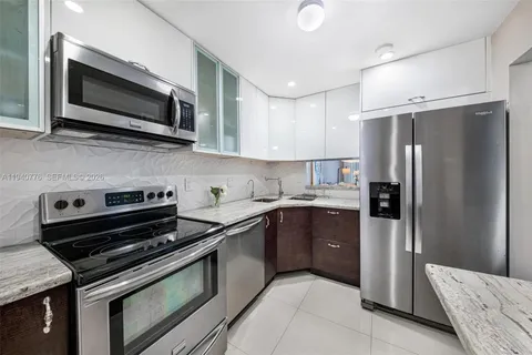 a kitchen with a refrigerator stove and microwave