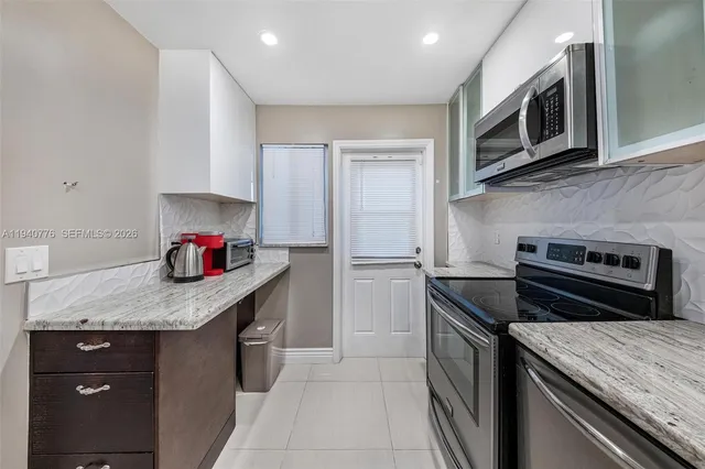 a kitchen with a stove microwave and cabinets
