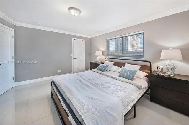 a bedroom with a bed and a night stand