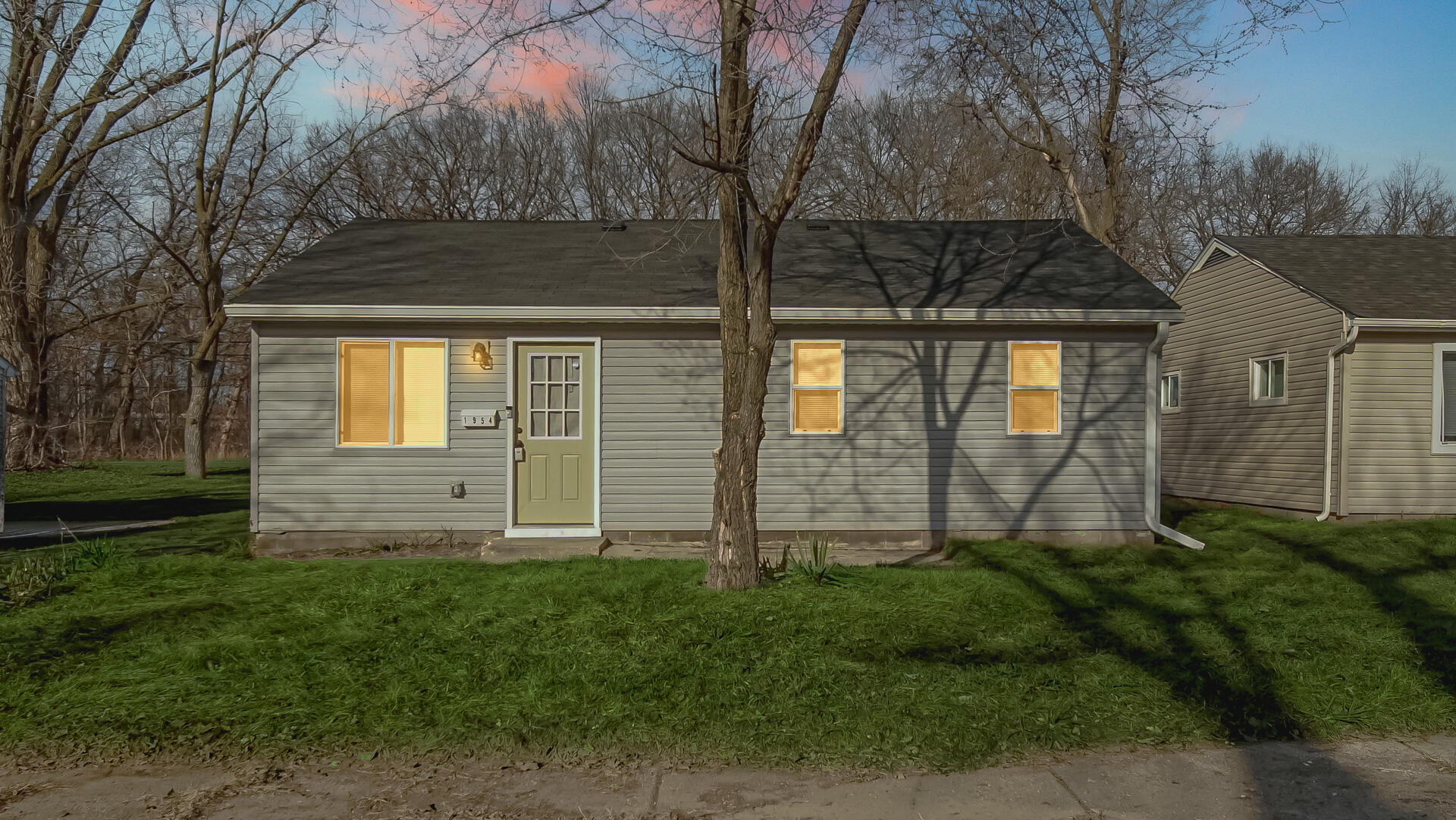 1954 Central Drive Gary, IN 46407 - Photo 2 of 22 a view of a house with a small yard and large tree