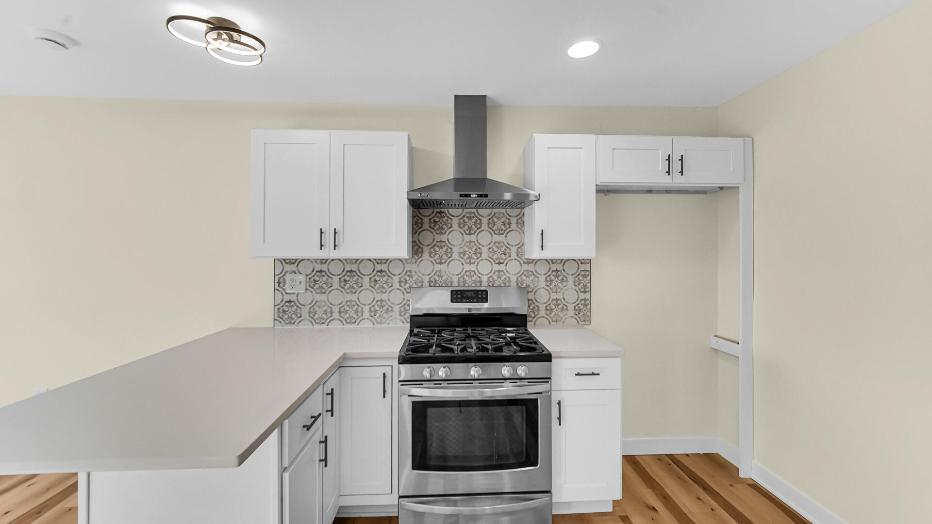 1954 Central Drive Gary, IN 46407 - Photo 10 of 22 a kitchen with a stove and white cabinets