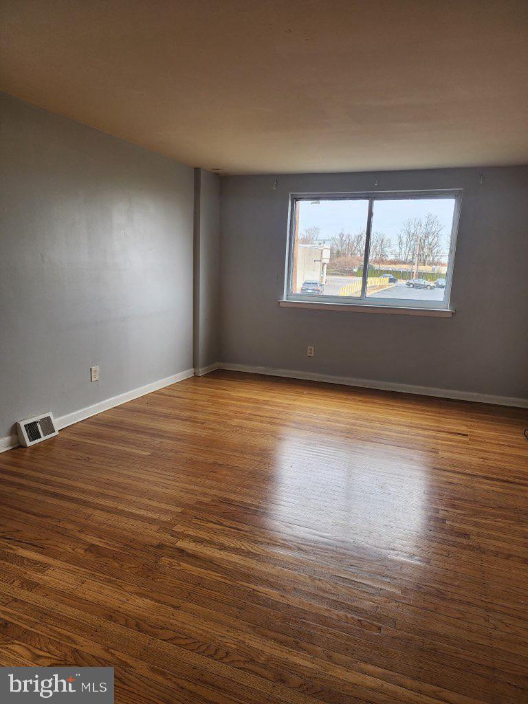 3324 Primrose Road Philadelphia, PA 19114 - Photo 1 of 6 a view of an empty room with wooden floor and a window