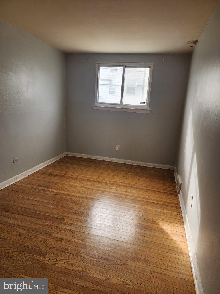 3324 Primrose Road Philadelphia, PA 19114 - Photo 5 of 6 an empty room with wooden floor and windows