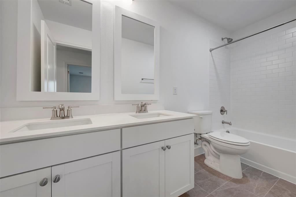 1004 Ashcroft Lane Justin, TX 76247 - Photo 22 of 39 a bathroom with a toilet sink and mirror