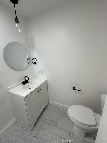 a bathroom with a sink mirror and toilet