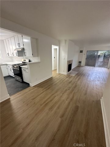 a bedroom with a bed and a view of kitchen