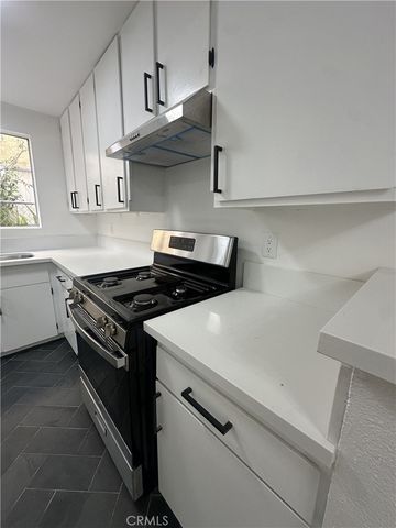 a white stove top oven sitting inside of a kitchen