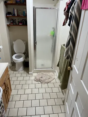 a bathroom with a toilet and a shower