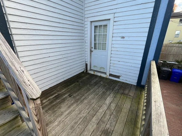 a view of a balcony with wooden floor