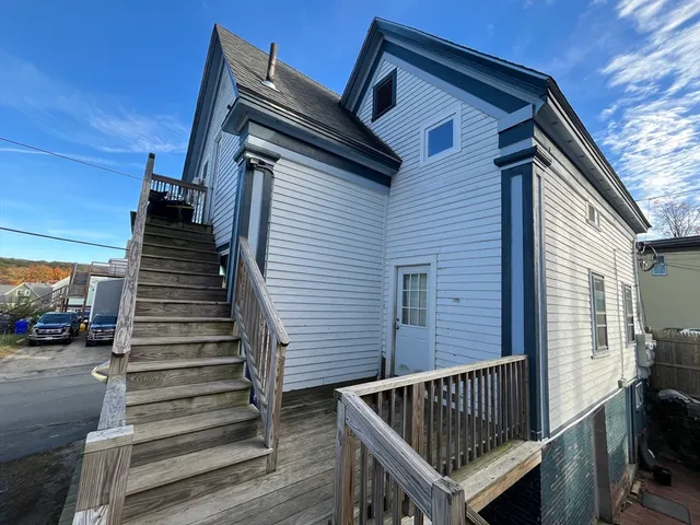 a view of entryway with wooden floor and stairs