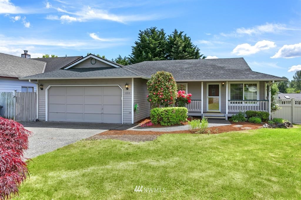 1310 233rd Place Southwest Bothell, WA 98021 - Photo 1 of 21 a front view of a house with a yard and garage