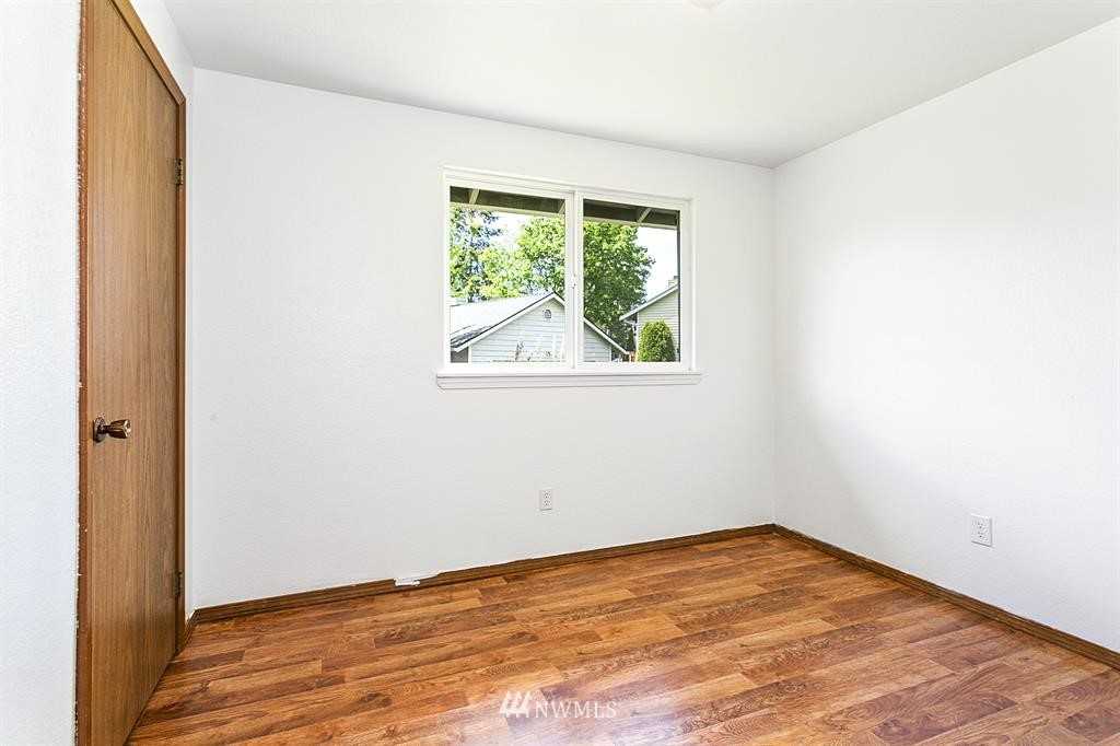 1310 233rd Place Southwest Bothell, WA 98021 - Photo 14 of 21 an empty room with wooden floor and a window