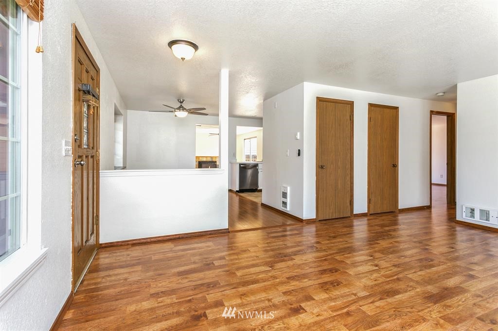 1310 233rd Place Southwest Bothell, WA 98021 - Photo 5 of 21 a view of a big room with wooden floor and windows