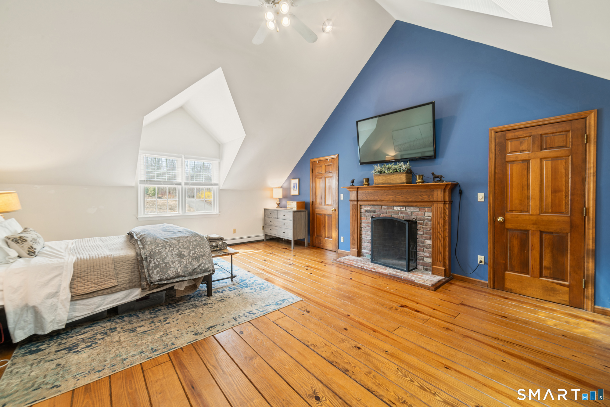110 Sleepy Hill Road Southbury, CT 06488 - Photo 15 of 40 Spacious and comfortable Primary bedroom with hardwood floor, plenty of closet space, skylights and full bathroom