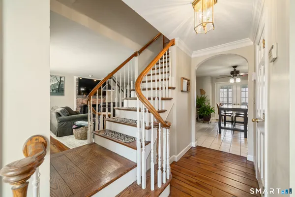 a view of entryway and hall with wooden floor