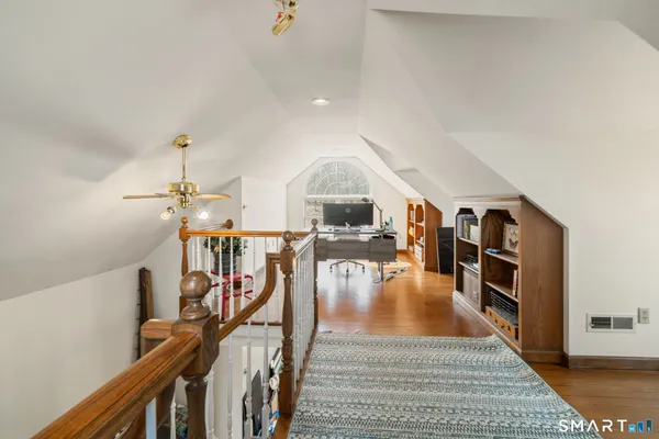 a view of a livingroom with furniture hardwood floor and a ceiling fan