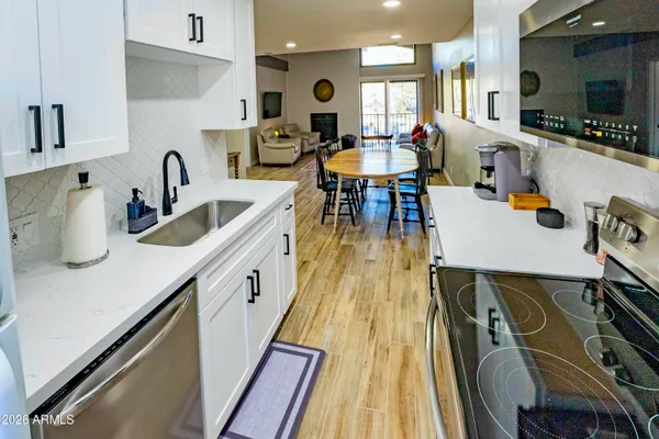 a kitchen with sink a refrigerator and cabinets