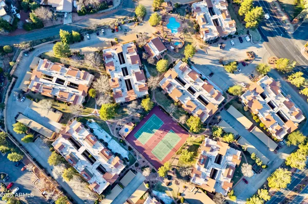 an aerial view of a house with a yard and outdoor seating