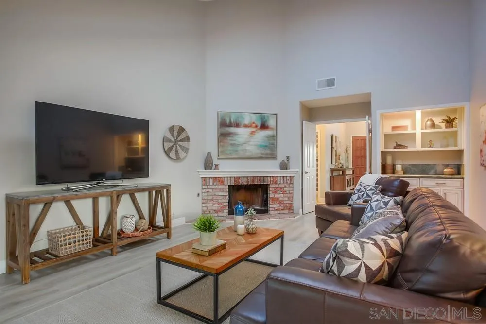 3534 Avenida Sierra Escondido, CA 92029 - Photo 13 of 38 a living room with furniture a flat screen tv and a fireplace