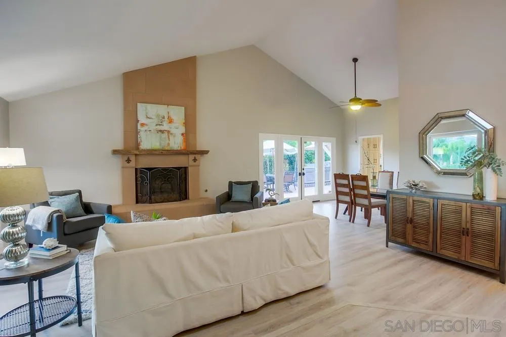 3534 Avenida Sierra Escondido, CA 92029 - Photo 6 of 38 a living room with furniture a fireplace and a chandelier