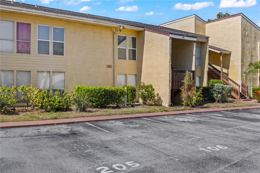 3405 Clark Road, Unit 205 Sarasota, FL 34231 - Photo 24 of 28 a front view of a house with a yard and a garage