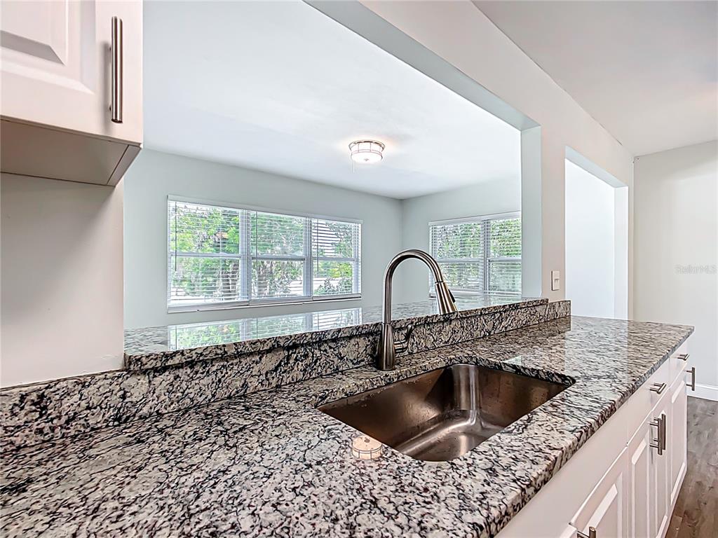 1406 Eden Drive Inverness, FL 34450 - Photo 12 of 41 a kitchen with a sink and a stove with wooden floor