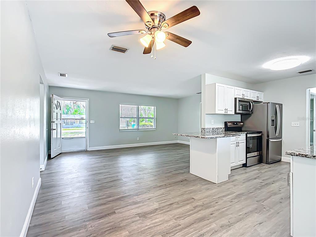1406 Eden Drive Inverness, FL 34450 - Photo 13 of 41 a view of kitchen with refrigerator microwave and stove top oven