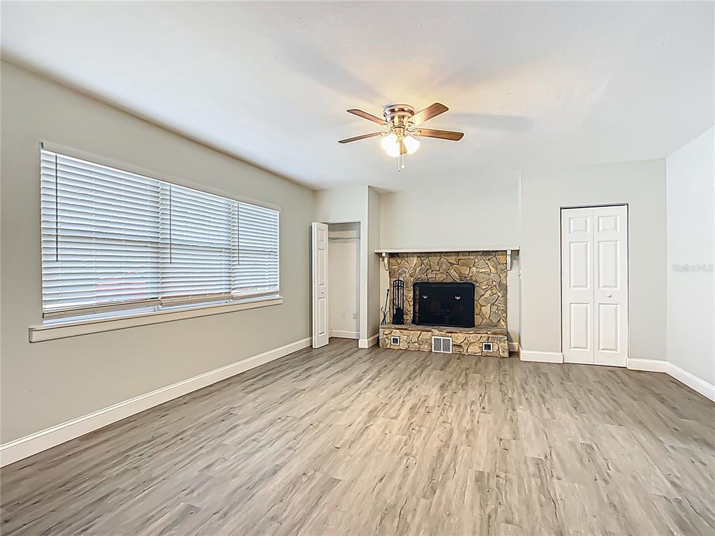 1406 Eden Drive Inverness, FL 34450 - Photo 15 of 41 a view of an empty room with a fireplace and a window