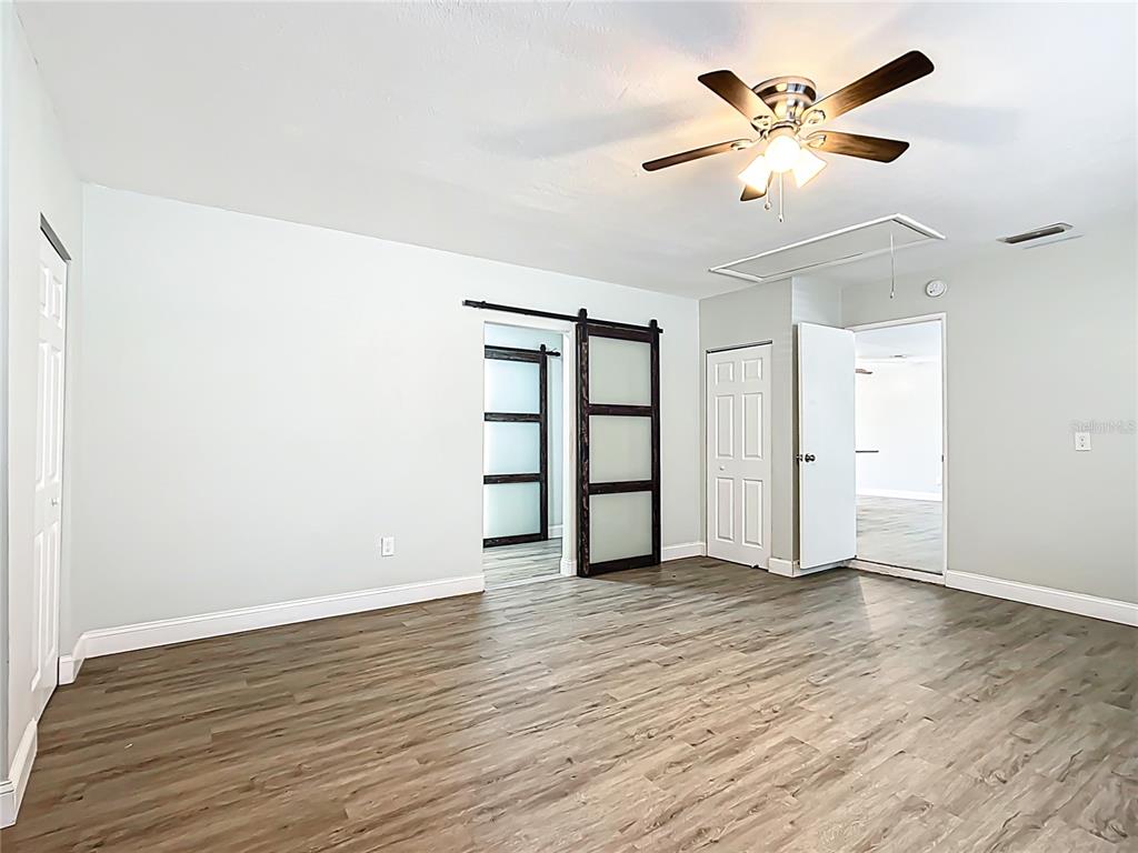1406 Eden Drive Inverness, FL 34450 - Photo 17 of 41 an empty room with wooden floor and ceiling fan