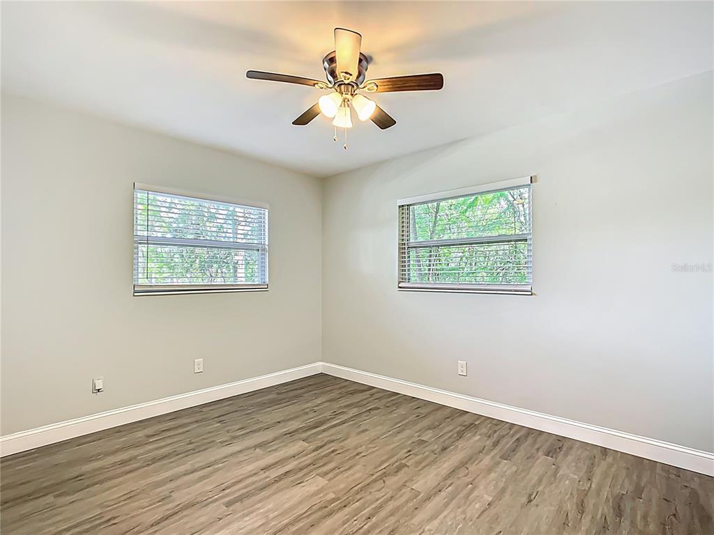 1406 Eden Drive Inverness, FL 34450 - Photo 21 of 41 an empty room with wooden floor and ceiling fan
