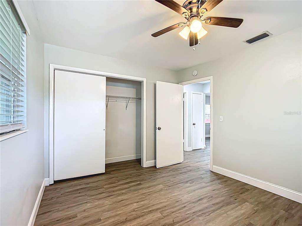 1406 Eden Drive Inverness, FL 34450 - Photo 24 of 41 an empty room with wooden floor closet and fan