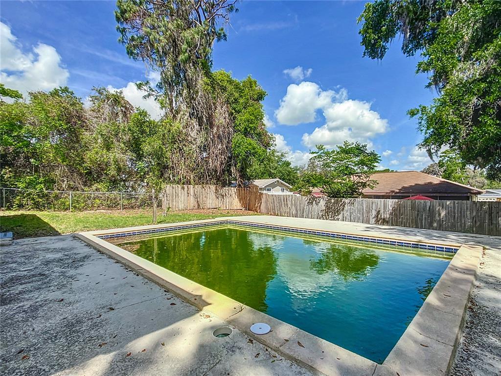 1406 Eden Drive Inverness, FL 34450 - Photo 34 of 41 a view of a swimming pool with a yard and plants