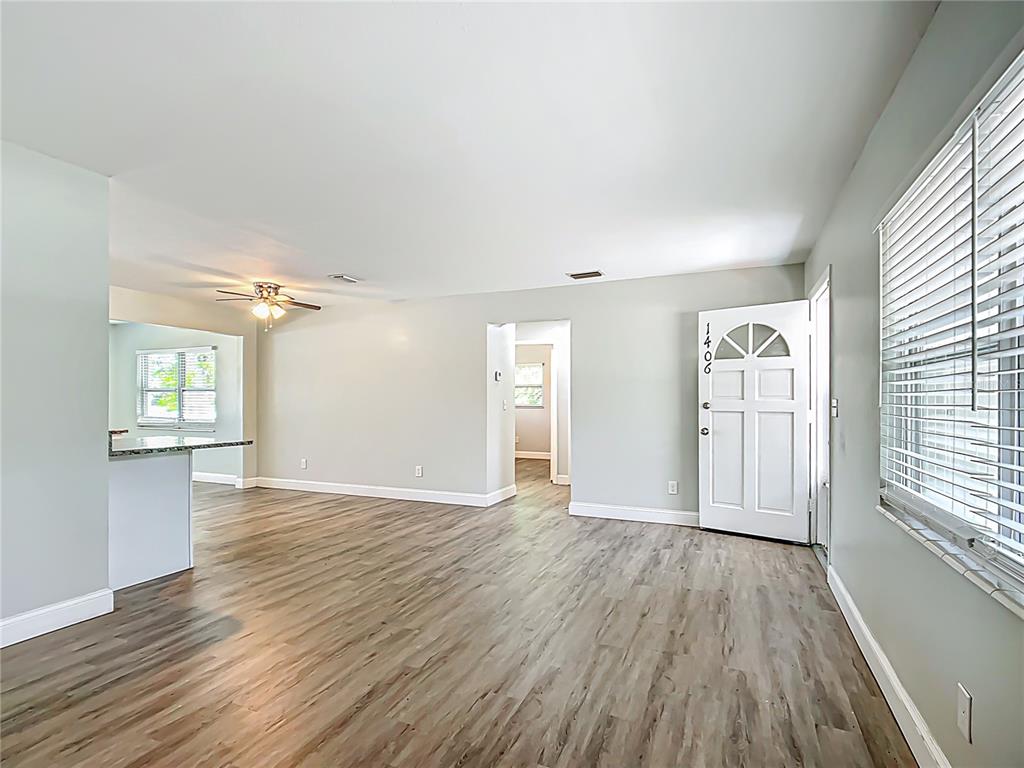1406 Eden Drive Inverness, FL 34450 - Photo 7 of 41 a view of an empty room with window and wooden floor