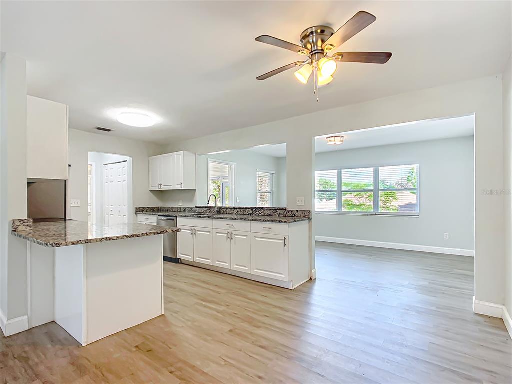 1406 Eden Drive Inverness, FL 34450 - Photo 8 of 41 a kitchen with stainless steel appliances granite countertop a stove cabinets and wooden floor