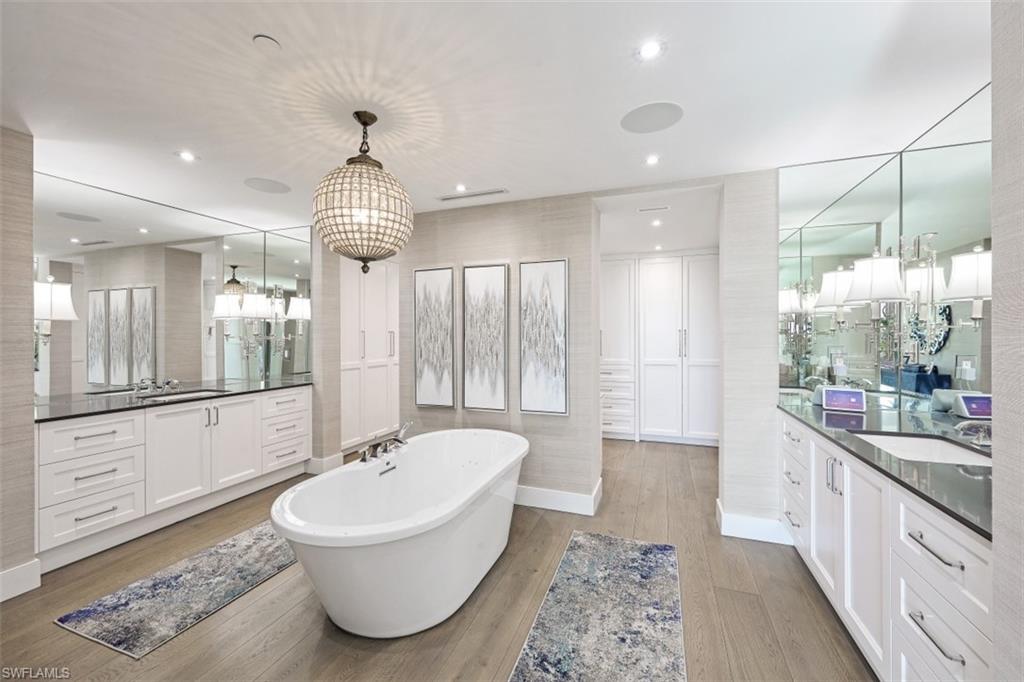 13915 Old Coast Road, Unit 305 Naples, FL 34110 - Photo 13 of 41 a bathroom with a tub sink and mirror