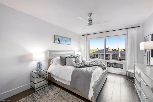 a bedroom with a bed and a lamp with window