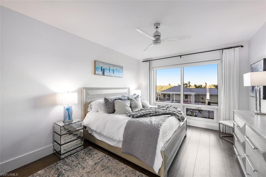 13915 Old Coast Road, Unit 305 Naples, FL 34110 - Photo 15 of 41 a bedroom with a bed and a lamp with window