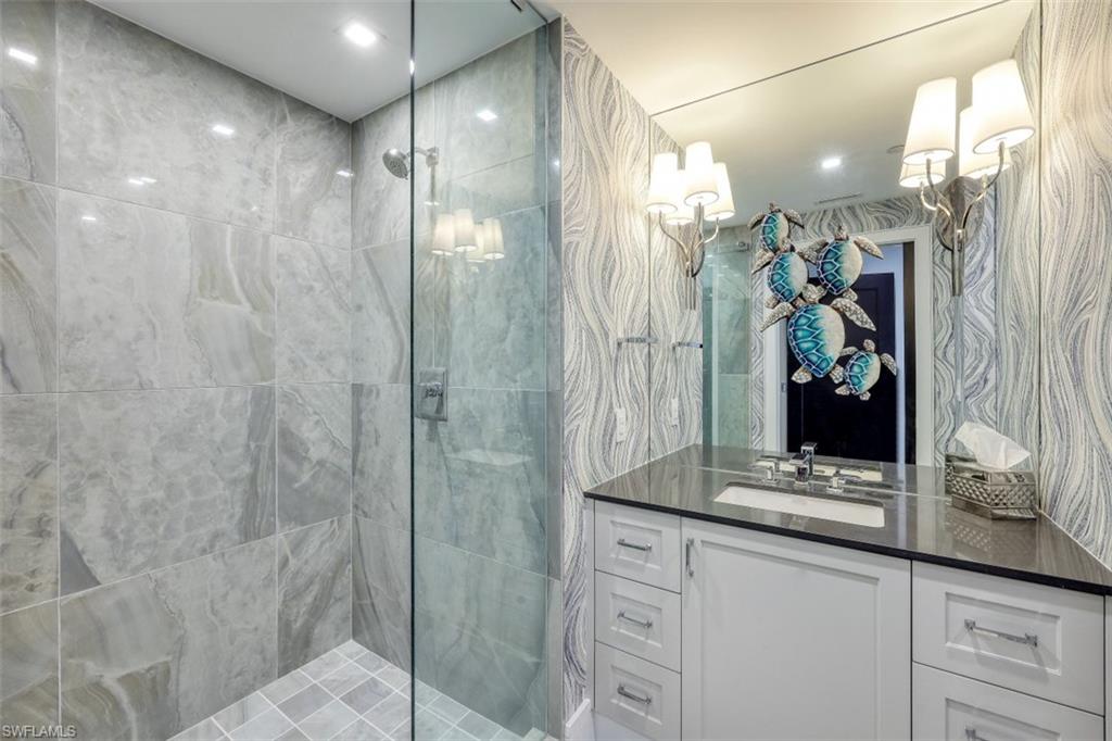 13915 Old Coast Road, Unit 305 Naples, FL 34110 - Photo 16 of 41 a bathroom with a shower and a sink