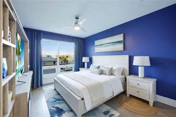 a bedroom with a bed and a large mirror